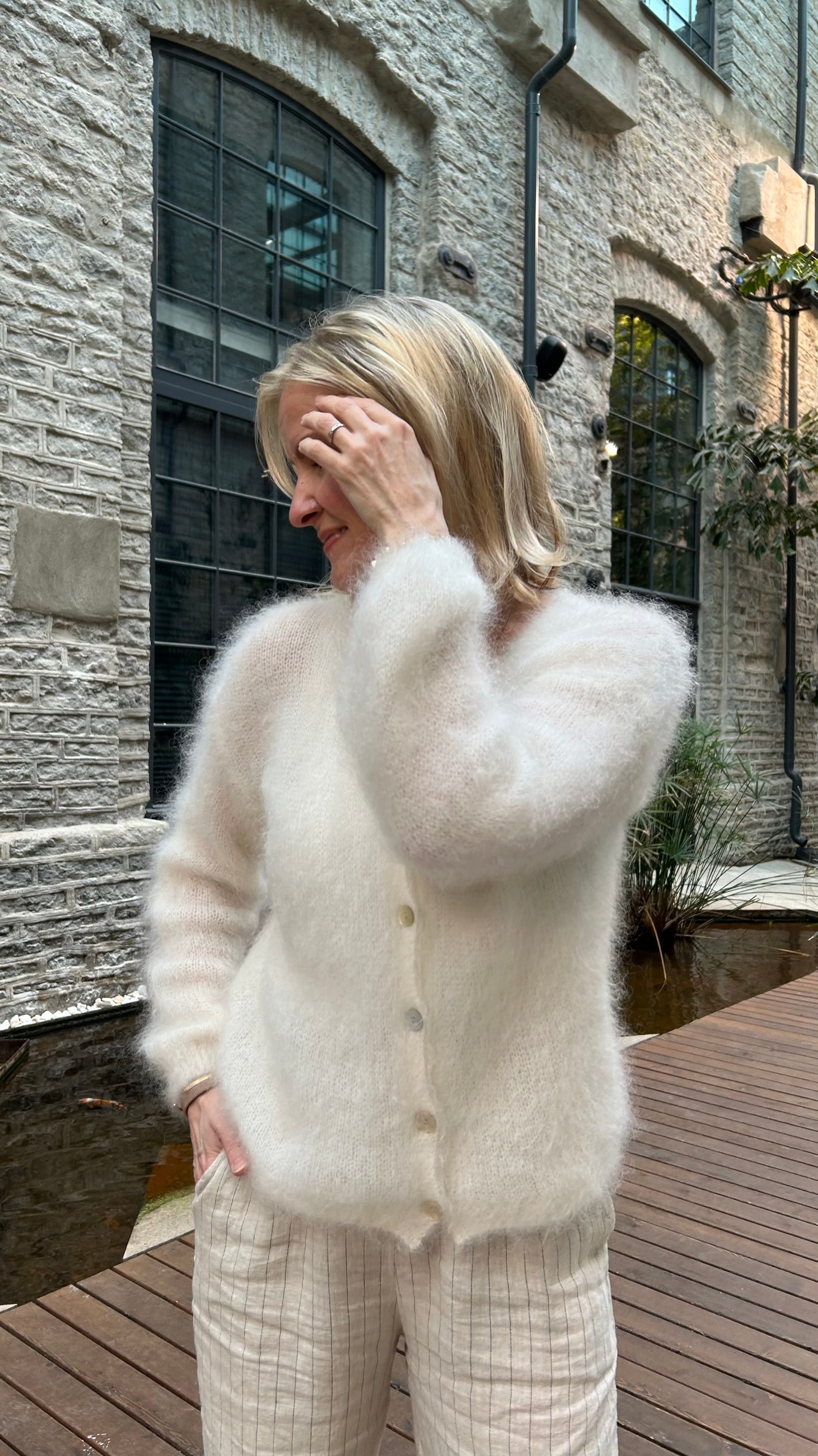 Women wearing off-white colored 80% kid mohair cardigan.